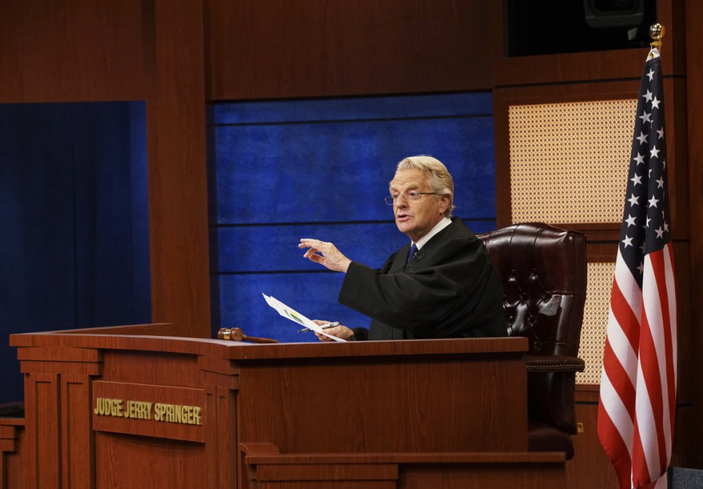 In this undated image provided by NBC, Jerry Springer appears in a scene from "Judge Jerry." NBC Universal Television Distribution on Monday announced the half-hour court program where Springer will hear testimony and render verdicts before a studio audience, that will debut in national syndication in the fall of 2019. (Bennett Raglin/NBC via AP)