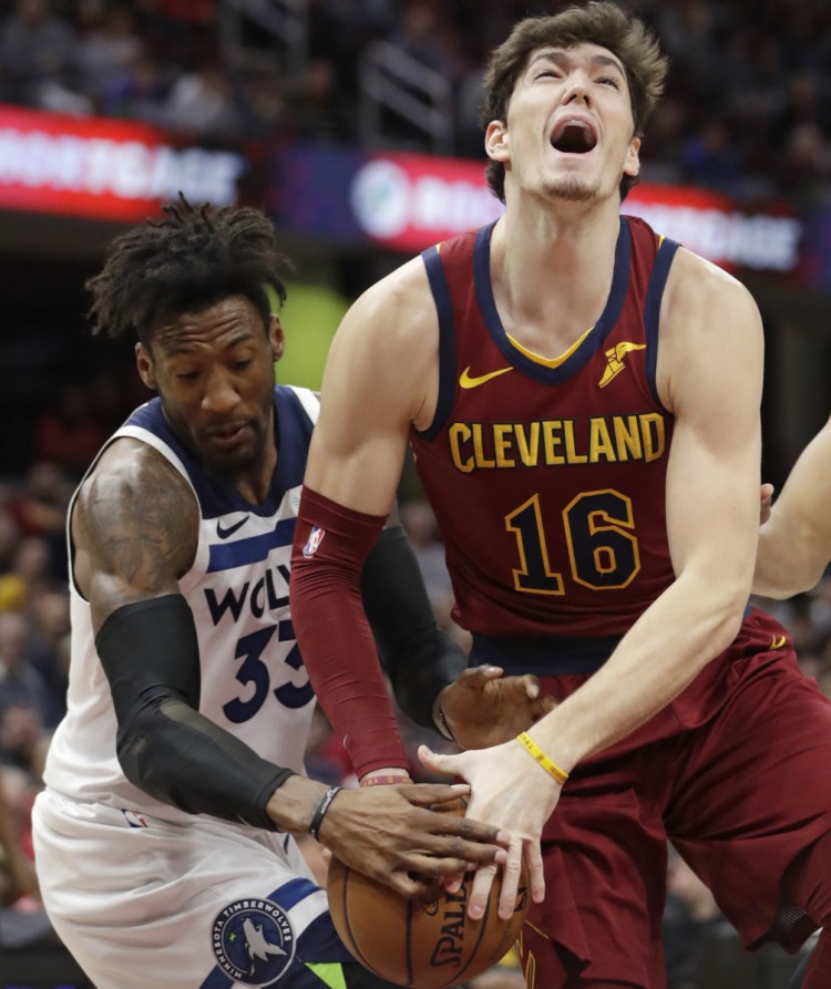 Minnesota's Robert Covington, left, knocks the ball loose from Cleveland's Cedi Osman during the Timberwolves' 102-95 win Monday in Cleveland.
