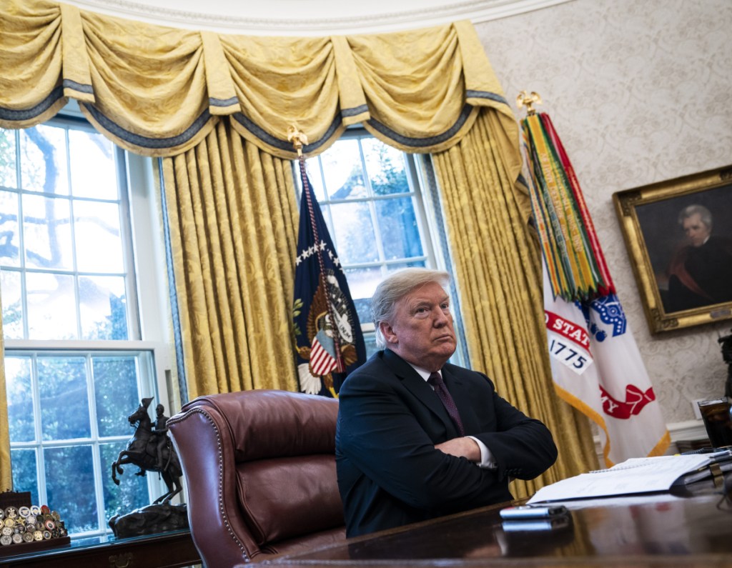 President Trump speaks with Washington Post reporters Tuesday in the Oval Office. He said the Fed has played a role in stock market declines and GM layoffs.