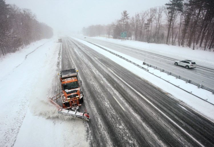 A plow works a southbound lane of the Maine Turnpike in Kennebunk in March. So far, the Department of Transportation has been able to cover 21,200 miles of state roads by moving crews around and putting managers behind the wheel.
