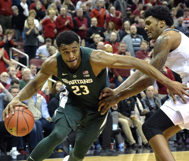 Michigan State forward Xavier Tillman attempts to drive past the defense of Louisville center Malik Williams during the Cardinals' 82-78 win at home Tuesday.