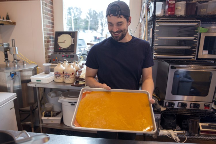 Sweetcream Dairy's Jonathan Denton holds the pepperoni toffee he made in collaboration with Biddeford's Pizza by Alex, which provided samples of its spice blend, cheese and pepperoni to help with the recipe.