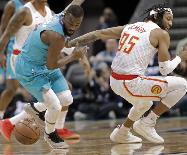 Charlotte's Kemba Walker, left, steals the ball from Atlanta's DeAndre' Bembry in the first half Wednesday night in Charlotte, N.C. The Hornets won, 108-94.