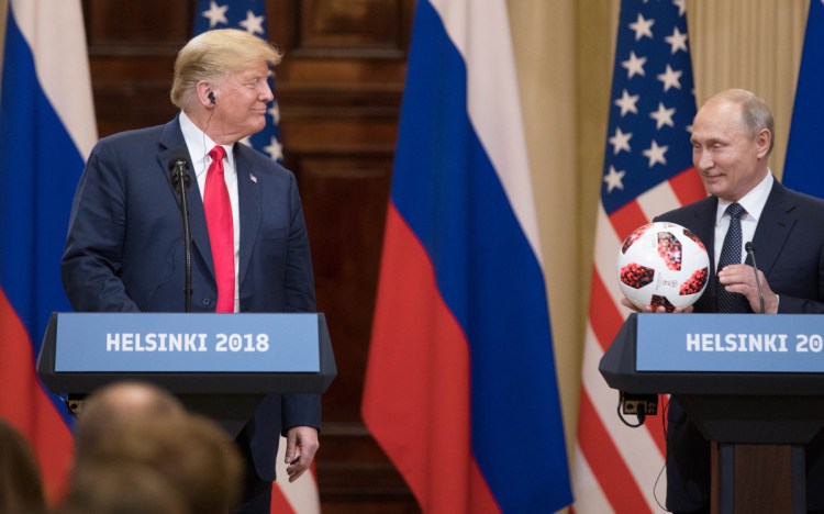 President Trump smiles while Vladimir Putin holds a soccer ball during a news conference in Helsinki, Finland, on July 16. Michael Cohen's guilty plea Thursday connected Trump's business and 2016 presidential campaign with the Russian government.