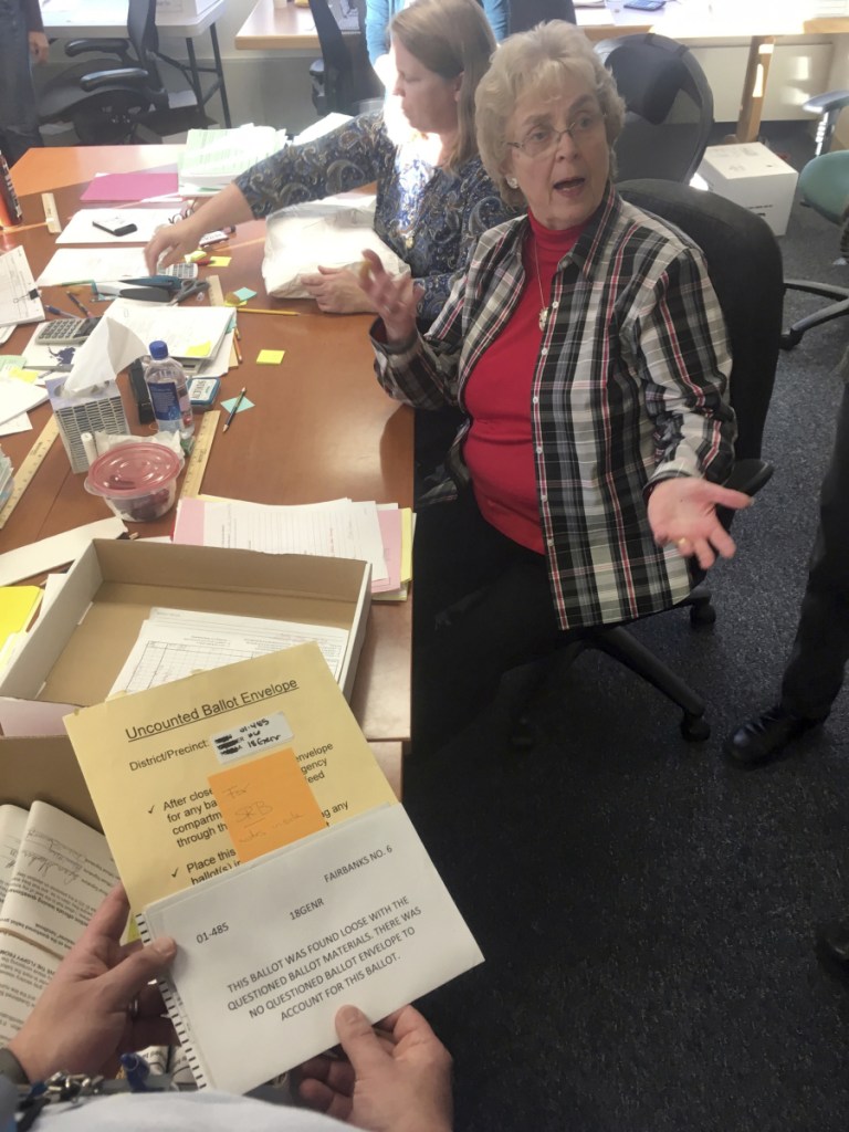 A State Review Board ballot examiner reacts when a loose ballot from a tied state House race is found without an envelope in Alaska.
