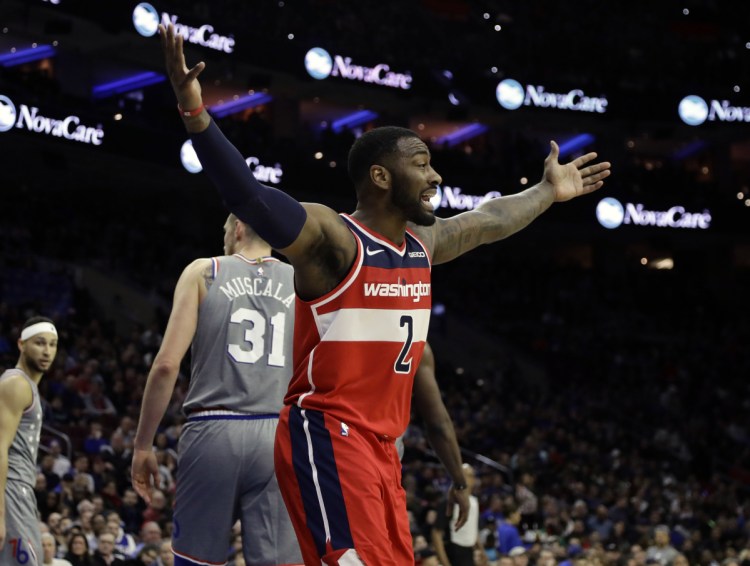 John Wall of the Washington Wizards reacts Friday night after being called for a foul during a 123-98 loss to the Philadelphia 76ers.