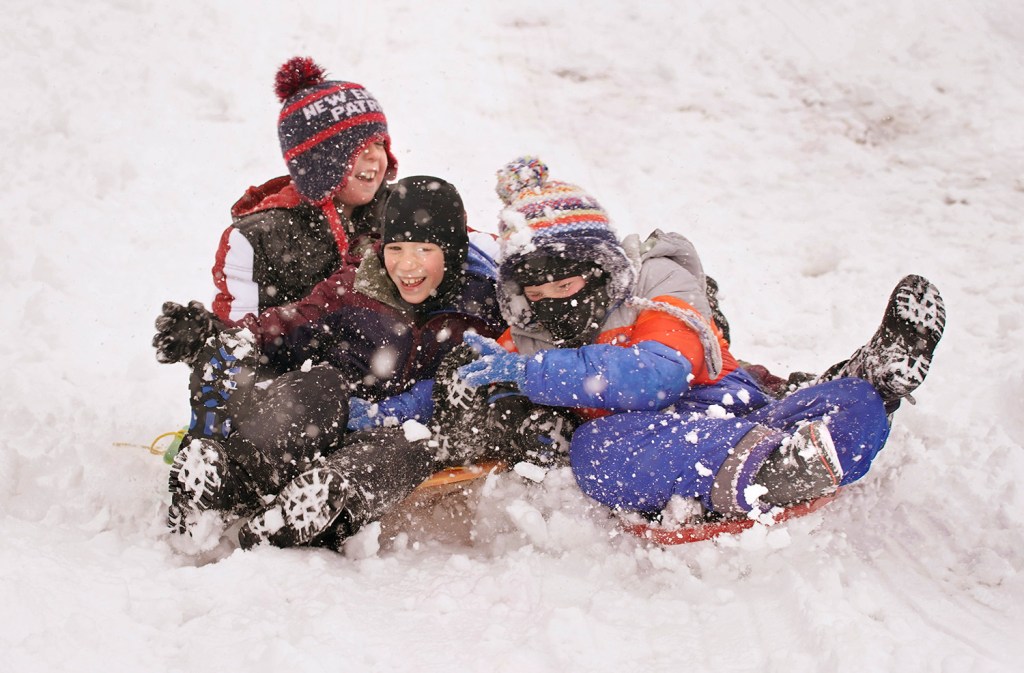 Taking advantage of a snow day from school, Cameron Douglas, 9, Cash Baker, 7 and Grady Foreman, 8, sled down a hill behind Scarborough High School on Nov. 20.