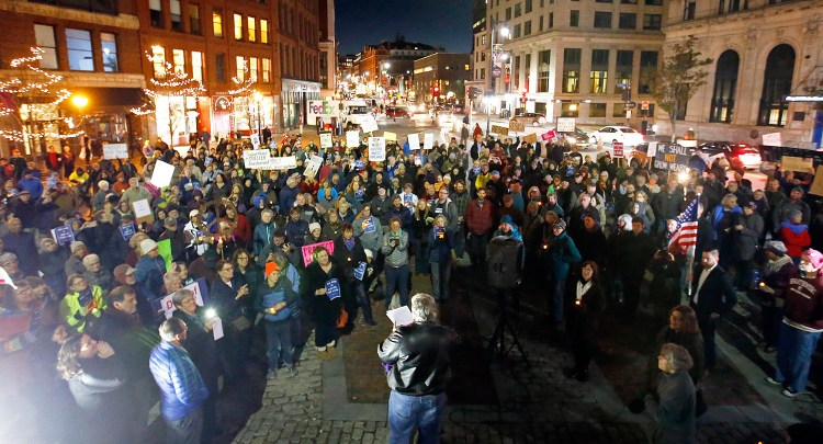 Historian Jackie McNeil, bottom center, addresses about 300 protesters gathered in Monument Square on Thursday evening to protest the impact that Attorney General Jeff Sessions' ouster could have on Special Counsel Robert Mueller's Russia probe.