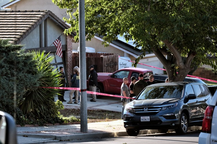 Ventura County Sheriff's deputies and FBI investigators stand outside the house of shooting suspect David Ian Long in Newbury Park, Calif., on Thursday,. Authorities said the former Marine opened fire at a country music bar in Southern California on Wednesday night, killing 12.