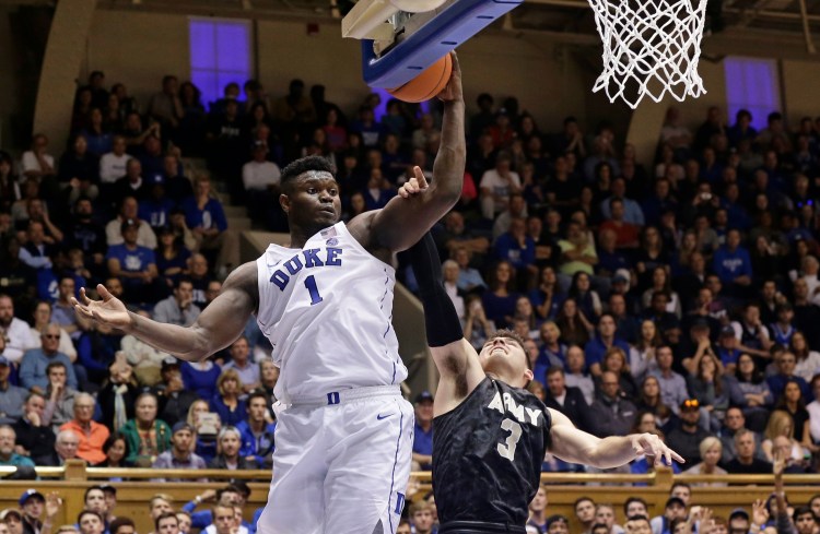 Duke's Zion Williamson (1) drives to the basket while Army's Tommy Funk (3) defends during the second half Sunday in Durham, North Carolina.