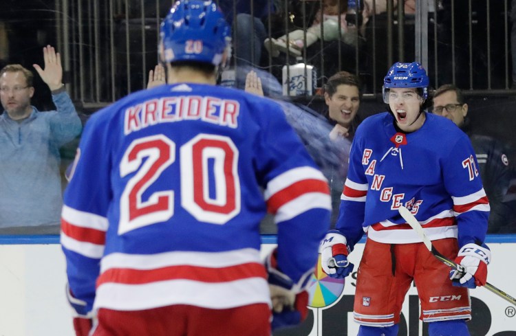 New York Rangers' Filip Chytil, right, celebrates after scoring a goal as teammate Chris Kreider (20) skates toward him during the second period against the Vancouver Canucks on Monday in New York. 