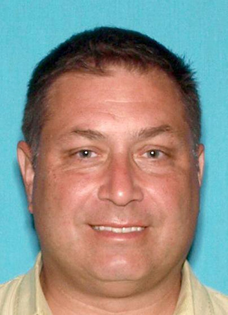 This image released by the Monmouth County Prosecutor’s Office, shows Paul Caneiro, who prosecutor charged Wednesday, Nov. 21, 2018, with aggravated arson. He's accused of setting fire to his own home in Ocean Township, N.J. That fire took place early Tuesday morning before authorities responded to a deadly blaze at the Colts Neck mansion owned by Caneiro's brother Keith and Keith's wife, Jennifer.