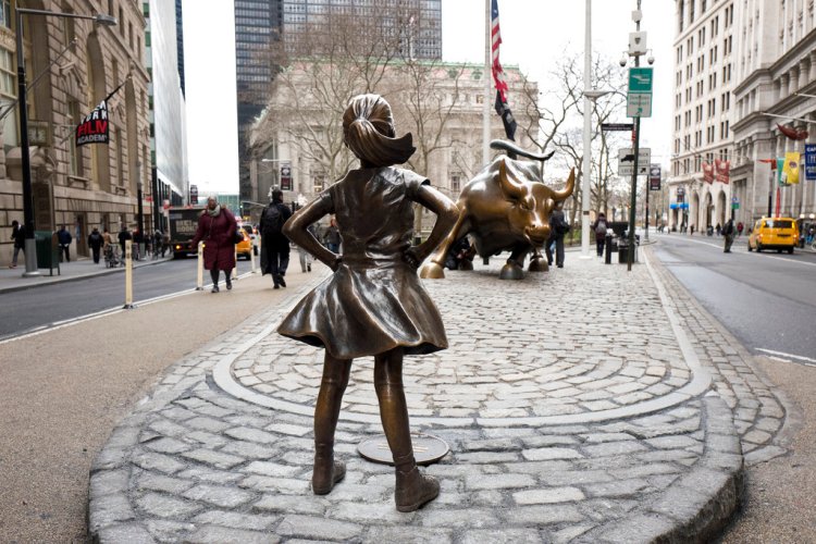 The "Fearless Girl" statue faces Wall Street's "Charging Bull" statue in New York in March 2017. The statue that has become a global symbol of female can-do business spirit, has been removed from her spot to await a new home by the New York Stock Exchange. 