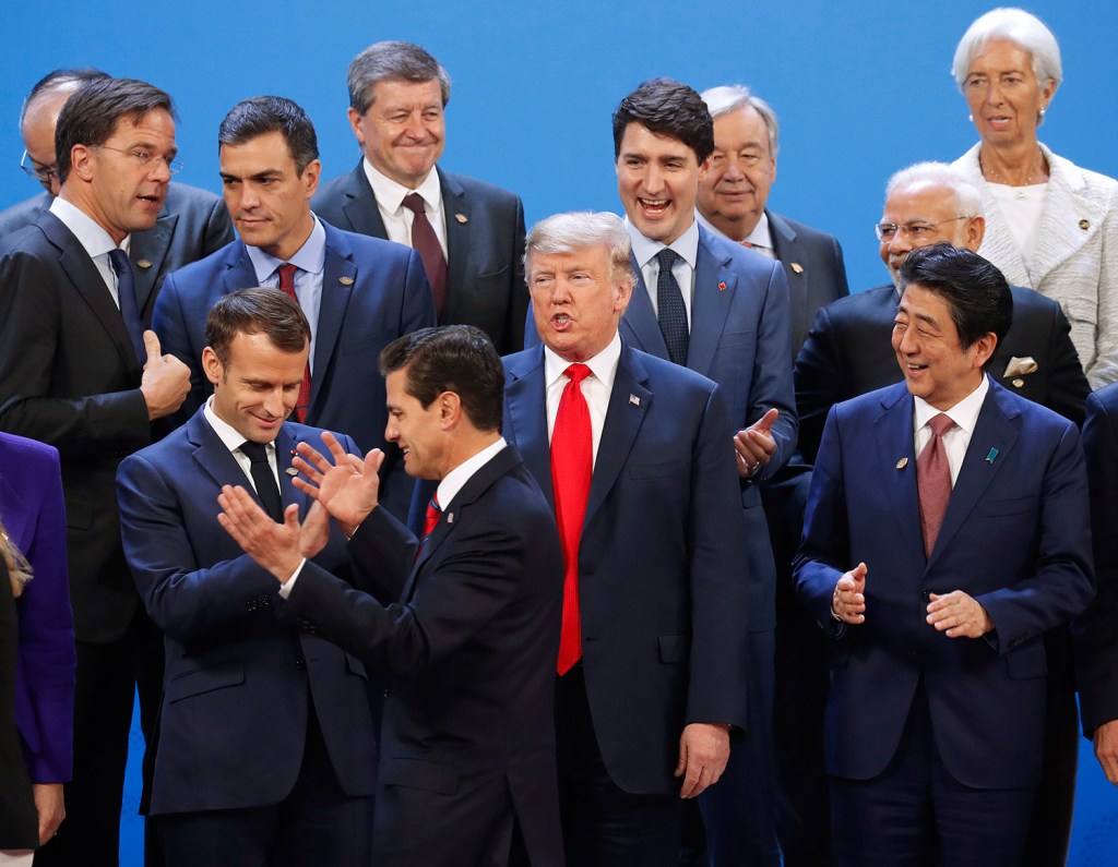 President Trump and other heads of state react to Mexico's President Enrique Pena Neto, throwing his hands up, being the last one to arrive for the group photo at the G20 summit, Friday in Buenos Aires, Argentina.