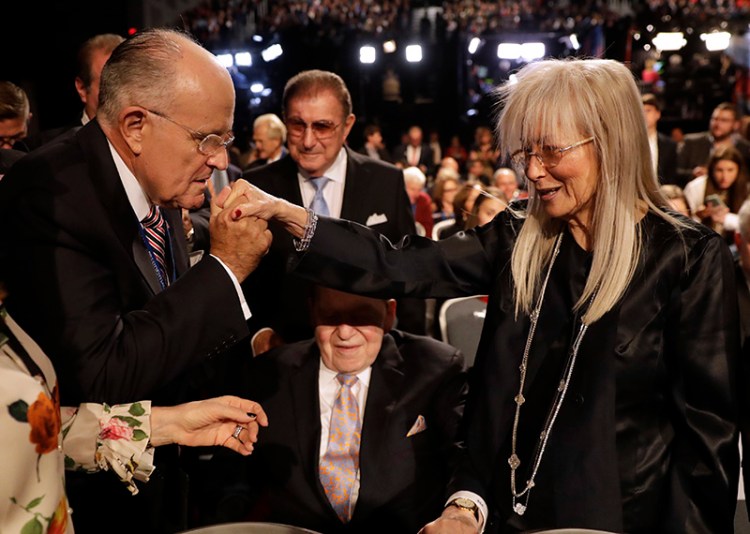 Former mayor of New York City Rudy Giuliani, kisses Miriam Adelson's hand at a presidential debate between Democrat Hillary Clinton and Republican Donald Trump in Hempstead, N.Y. in 2016.