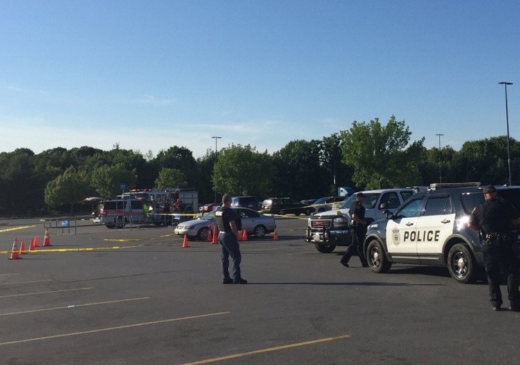 Police gather at the Augusta Wal-Mart parking lot on June 26, 2016, after a dispute over money and drugs led to shots being fired.