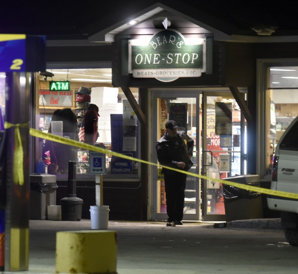 A police officer exits the Bear's One Stop store in Newport as other investigators inside speak with employees after a shooting Wednesday evening.