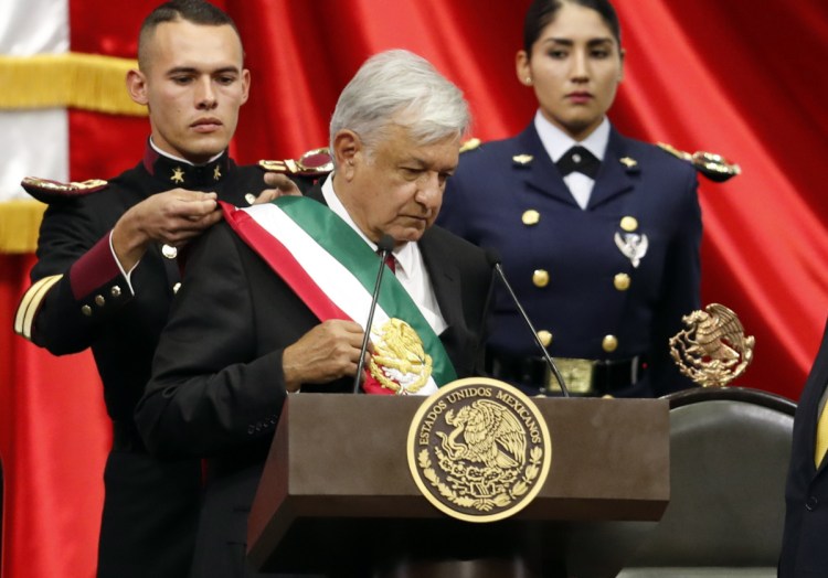 Mexico's new President Andres Manuel Lopez Obrador receives the presidential sash during the inaugural ceremony Saturday in Mexico City.