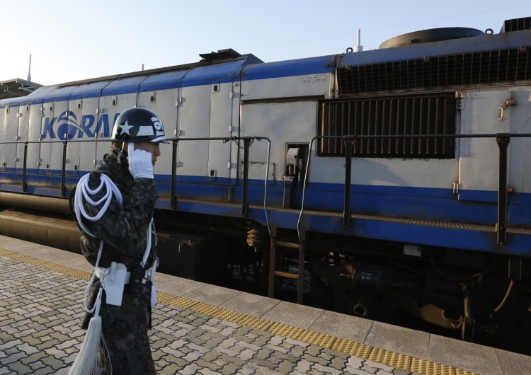 A South Korean soldier stands next to the train about to travel across the border into North Korea at the Dorasan Station in Paju, South Korea, Friday. The train pulled six cars filled with dozens of South Korean expert and officials who will undertake an 18-day, 750-mile survey of railway tracks in the North.