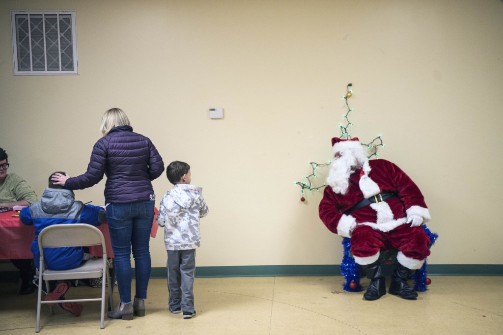 Santa Claus greets children Saturday at the Humane Society Waterville Area shelter in Waterville. The organization held an open house that day to raise money to keep the shelter open.