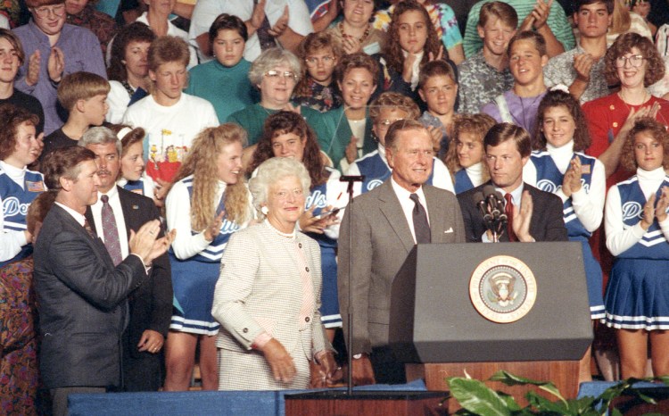 President George H.W. Bush and the first lady receive a round of applause during his visit to Lewiston High School in 1991.