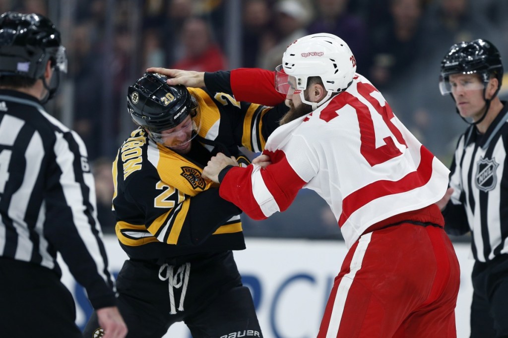 Joakim Nordstrom, left, of the Bruins fights with Detroit Luke Witkowski during the Red Wings' 4-2 win Saturday night at TD Garden.
