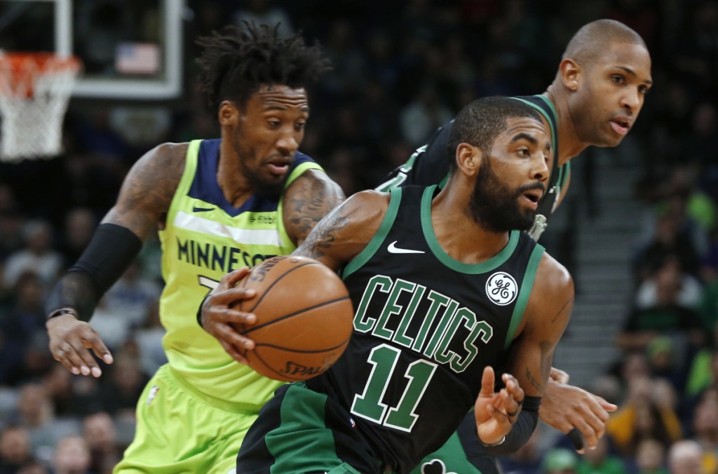 Kyrie Irving drives past Minnesota's Robert Covington during Boston's 118-109 win Saturday night in Minneapolis. Irving finished with 21 points and nine assists.