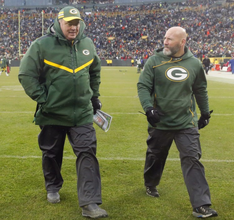 Mike McCarthy, left, leaves the field Sunday for the final time as the Green Bay Packers' coach, following a loss to the Arizona Cardinals.