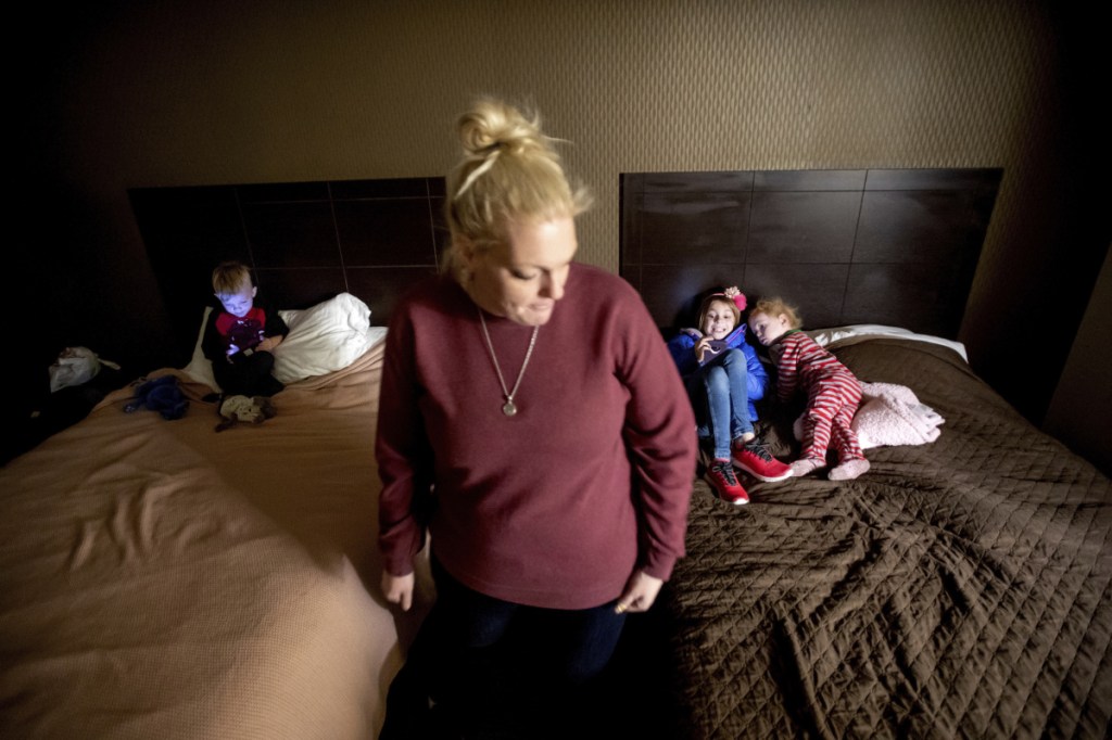 Erica Hall pauses Monday in Yuba City, Calif., while preparing her children for their first day of school since the Camp Fire destroyed their home. The family, who lost their five-bedroom home in Paradise, Calif., plans to stay in a hotel room through February.
