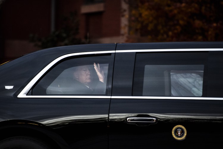 President Trump leaves in the presidential parade limousine after meeting at the Blair House with former President George W. Bush and his wife, Laura.