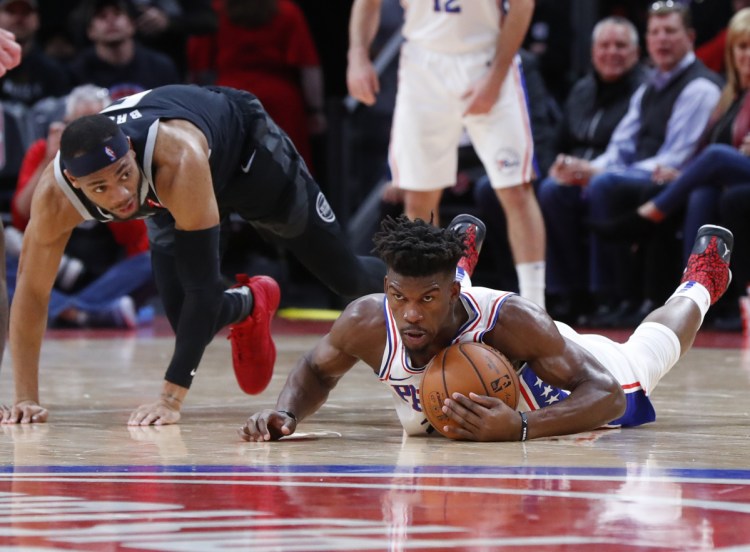 Philadelphia 76ers guard Jimmy Butler collects the ball from Detroit Pistons guard Bruce Brown during the first half of their game in Detroit on Friday night. The 76ers won 117-111 despite resting Joel Embiid.