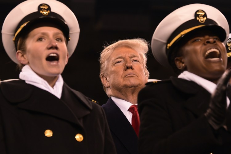 President Trump attends the Army-Navy football game in Philadelphia on Saturday, a day after court filings tied him to a federal crime.