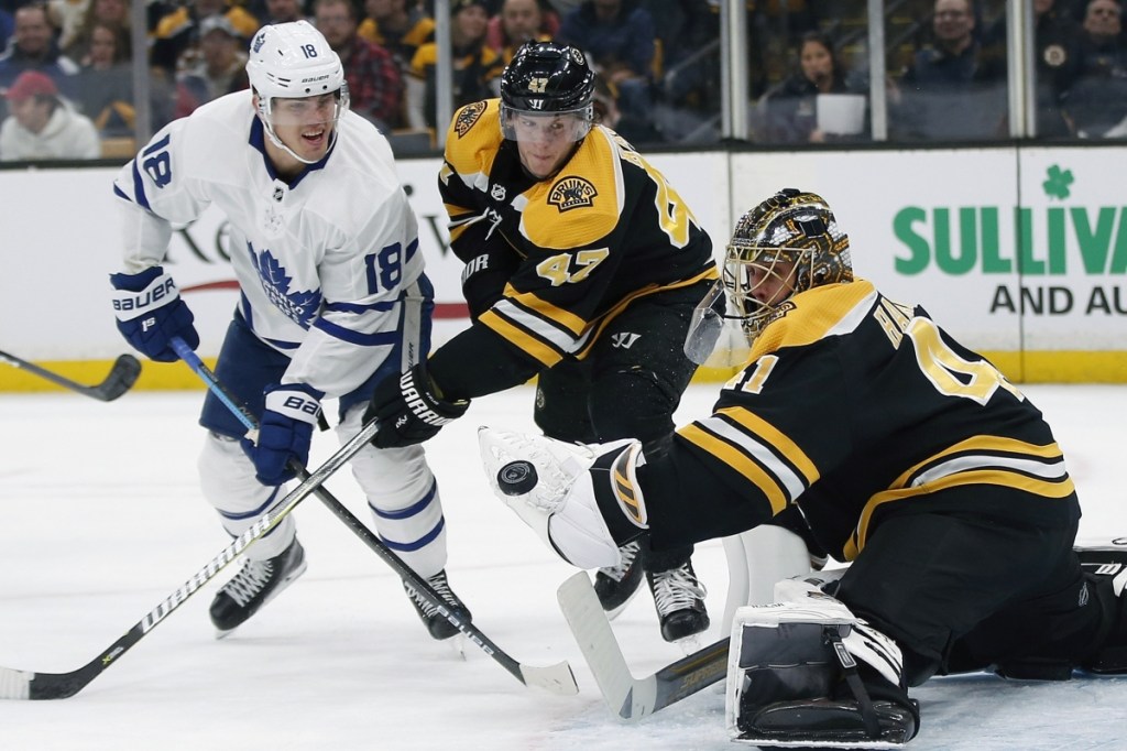 Bruins goalie Jaroslav Halak makes a save as defenseman Tory Krug fights for the rebound with Andreas Johnsson of the Maple Leafs during Boston's 6-3 win Saturday night.