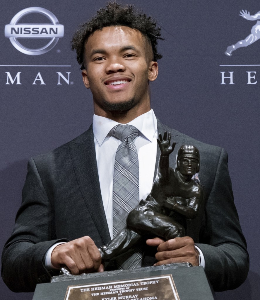 Kyler Murray poses Saturday with the Heisman Trophy after becoming the second straight Oklahoma quarterback to win the award.