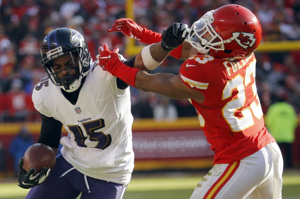 Ravens wide receiver Michael Crabtree tries to fend off Kansas City cornerback Kendall Fuller during the Chiefs' 27-24 overtime victory Sunday in Kansas City, Mo.