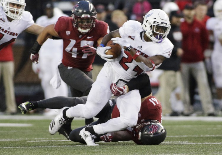 Eastern Washington running back Tamarick Pierce, top, is part of an offense that averages 538.3 yards per game. Maine defense allows 293.5 yards per game.