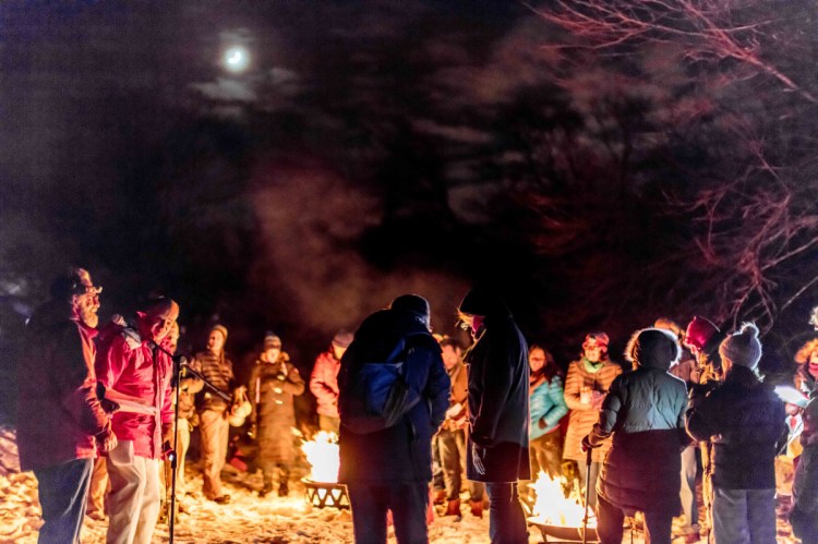 People celebrate a past winter solstice around a fire at Houghton Graves Park on Orr's Island.