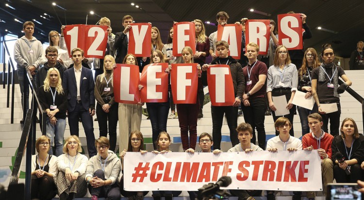 Polish teenagers protest at the U.N. climate summit in Katowice, Poland, on Friday to urge negotiators from almost 200 countries to reach an agreement on ways of keeping global warming in check.