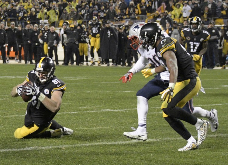 The catch wasn't a catch for Pittsburgh's tight end Jesse James, left, last December against the Patriots. The apparent touchdown was reversed in the final minute, and New England held on for a 27-24 win, securing the top seed in the AFC.