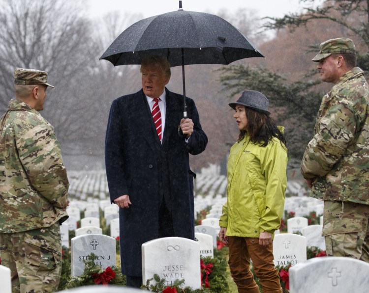 President Trump visits Arlington National Cemetery in Arlington, Va., on Saturday during Wreaths Across America Day. 