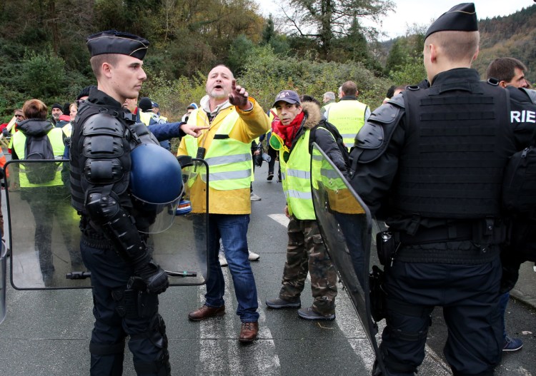 French police officers disperse demonstrators wearing yellow vests in Biriatou on Saturday.

