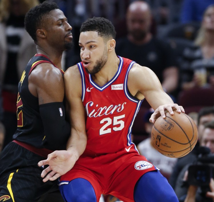 Ben Simmons of the 76ers backs in against Cleveland's David Nwaba during Philadelphia's 128-105 win Sunday.
