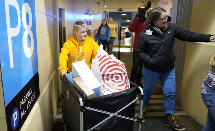 Sam Rideout, 10, of South Portland wheels a bin of toys into Maine Medical Center on Monday. He raised $6,371 for his toy drive this year, to benefit kids at Barbara Bush Children's Hospital.