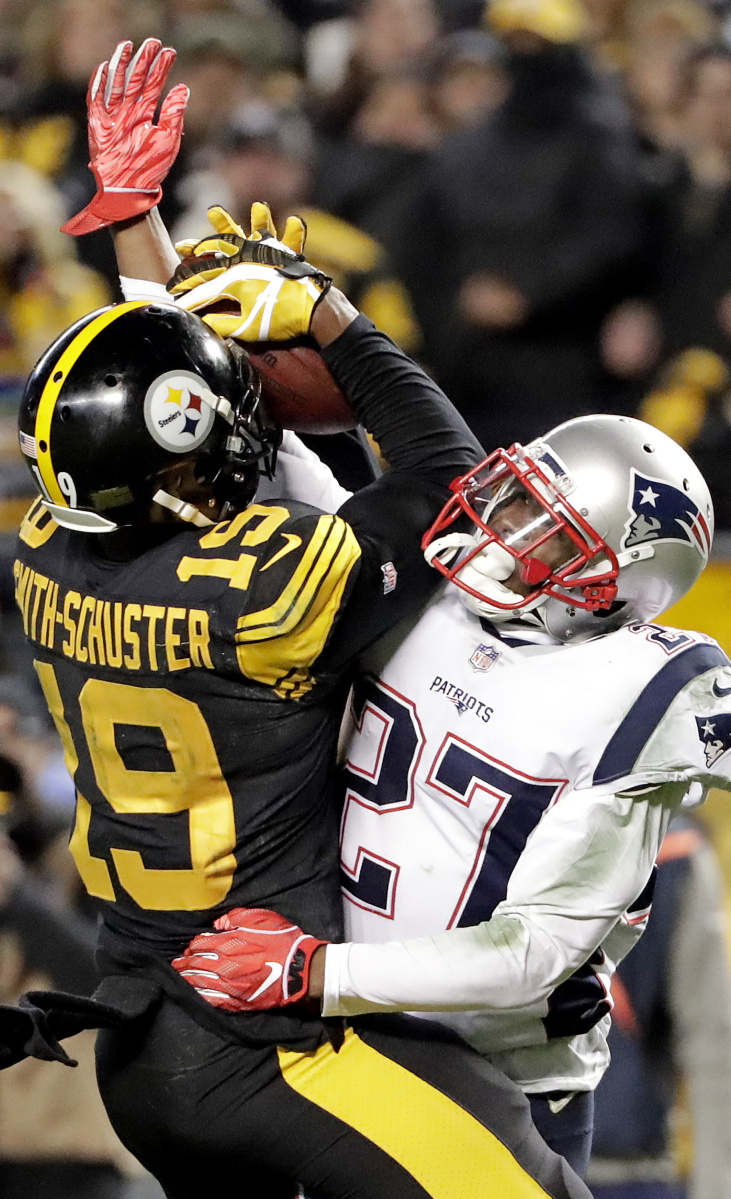 Steelers receiver JuJu Smith-Schuster hauls in pass despite tight coverage by Patriots cornerback J.C. Jackson on Sunday in Pittsburgh. Jackson held Smith-Schuster to four catches.