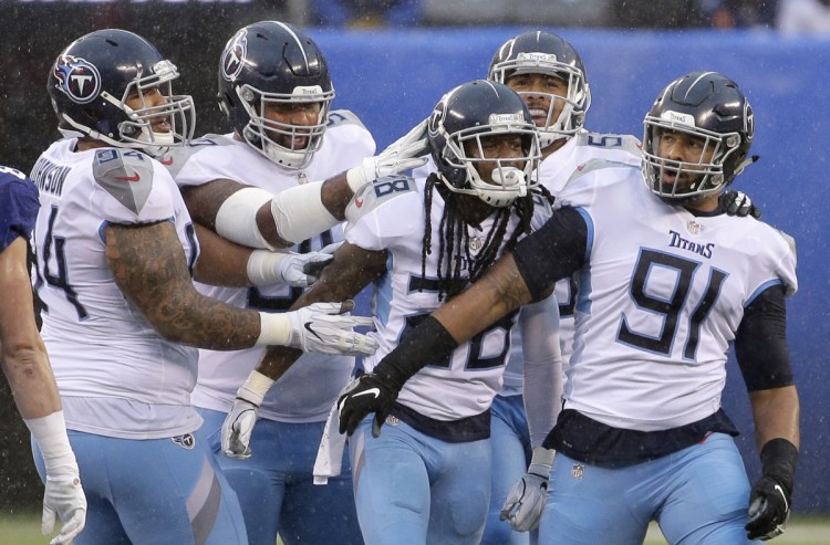 Titans strong safety Kendrick Lewis, center, with teammates during Tennessee's 17-0 win over the Giants, which kept their playoff dreams alive.