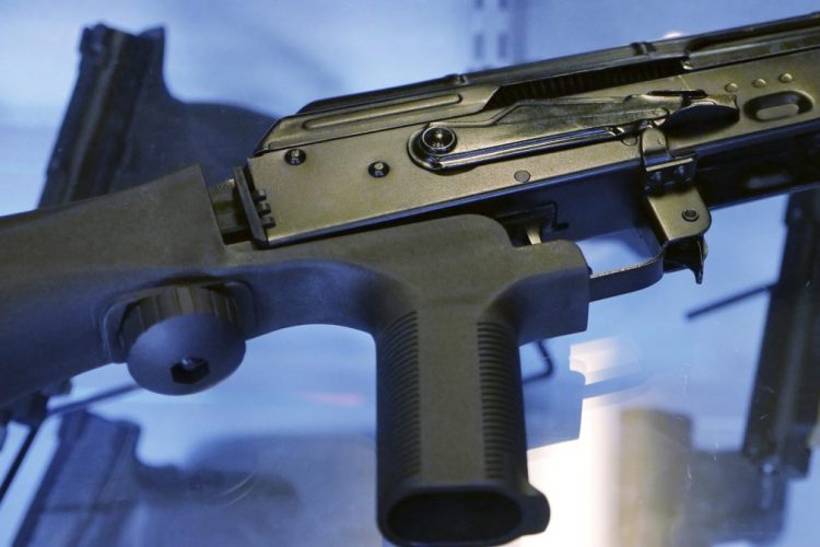 A bump stock is attached to a semi-automatic rifle at the Gun Vault store and shooting range in South Jordan, Utah. The Trump administration is moving to ban bump stocks, which allow semi-automatic weapons to fire rapidly like automatic firearms.