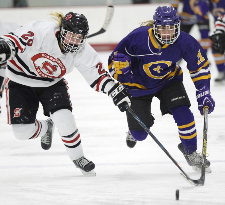 Scarborough's Maya Sellinger, left, and Sophia Pomeo of Cheverus/Kennebunk chase a loose puck Wednesday at USM Ice Arena. Cheverus recorded its fourth shutout in eight games this season.