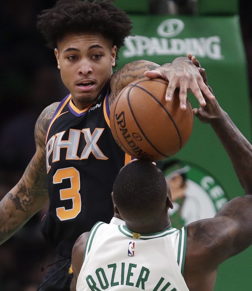 Phoenix Suns guard Kelly Oubre Jr. stuffs the ball back at Boston guard Terry Rozier during Wednesday's game in Boston.