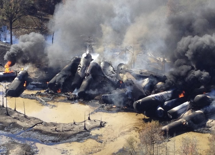 A tanker train carrying crude oil burns after derailing in western Alabama in 2013. The Trump administration vastly understated the potential benefits of installing more advanced brakes on trains that haul explosive fuels.