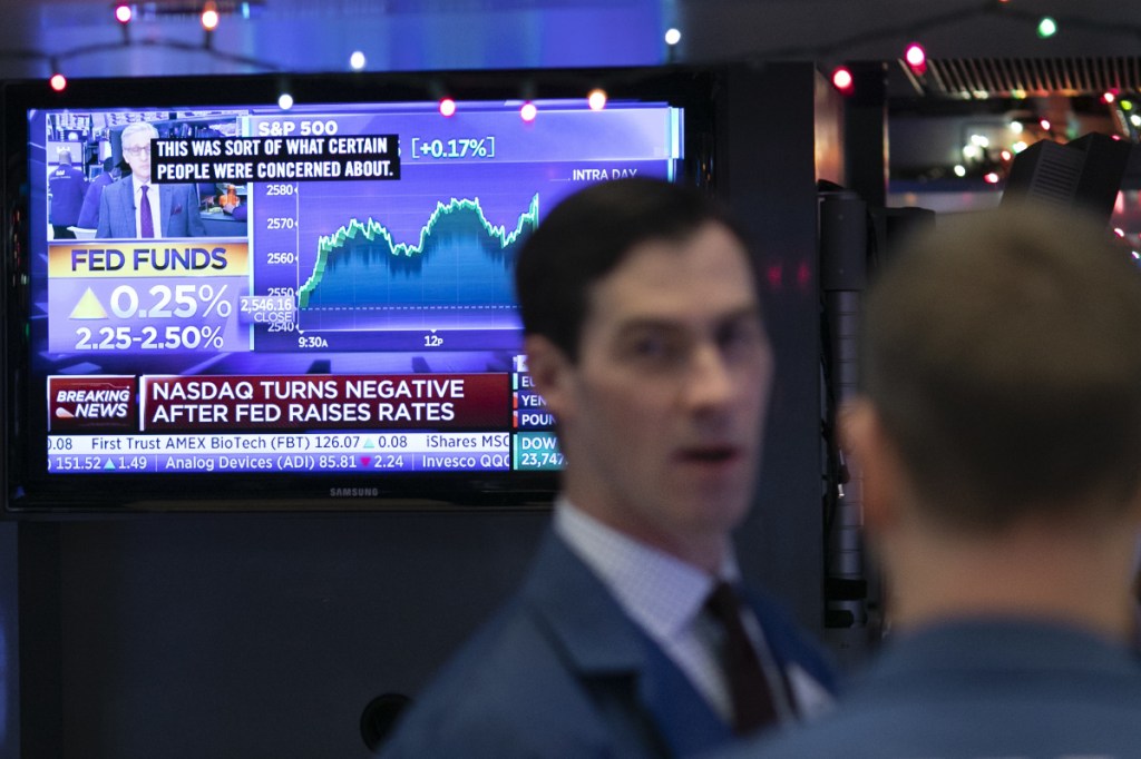 A television screen at the New York Stock Exchange relays the news that the Federal Reserve Board announced a rate increase Wednesday. The market responded with a two-day selloff of U.S. stocks.